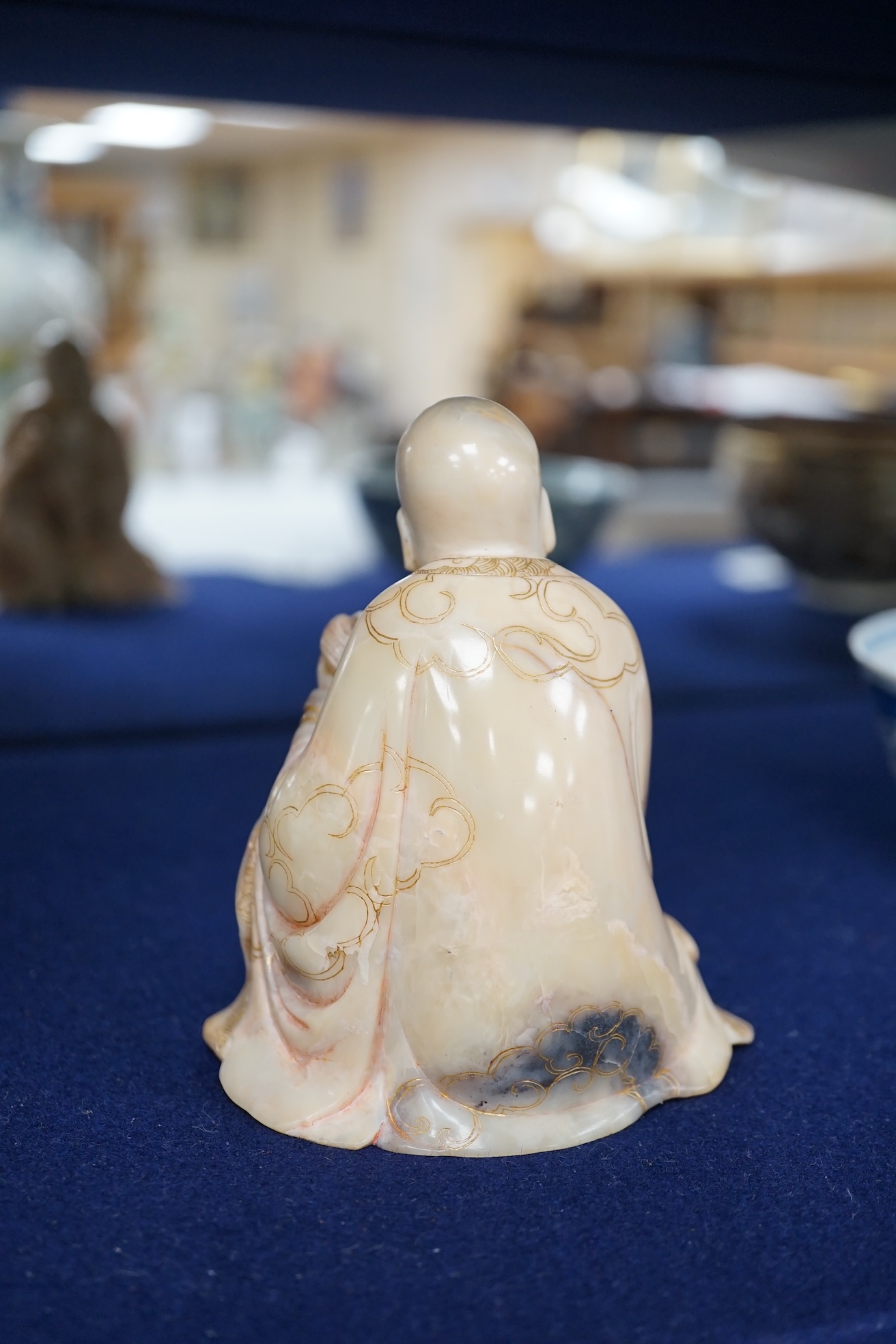 An 18th century carved soapstone figure of a seated luohan, 12cm high. Condition - good